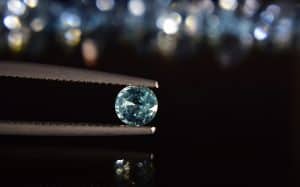 A diamond held in tweezers - in a pandemic are your the diamond or the coal?